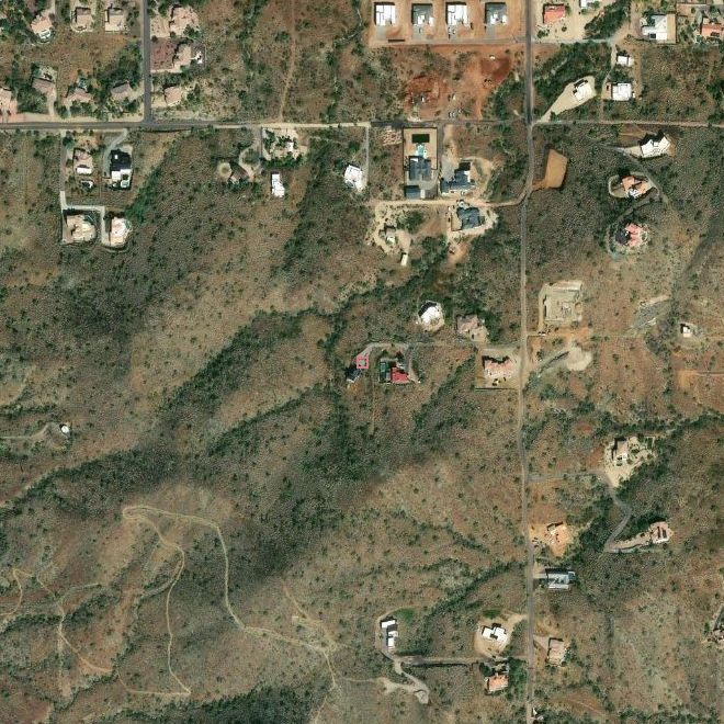 Satellite view of the vineyard lot and the surrounding desert foothills, house footprint outlined in wine.