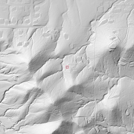 Grayscale 2-metre hillshade of the hill at sun azimuth 315 degrees: the hill casts its shadow across the drainage lines below.